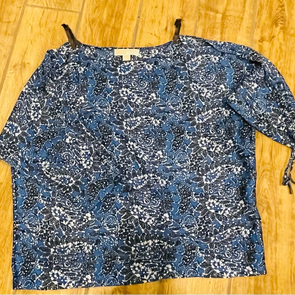 Michael Kors peek-a-boo 3/4 sleeve top with leather straps at shoulder.